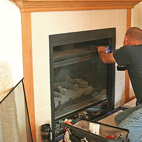 Technician Fixing Fireplace
